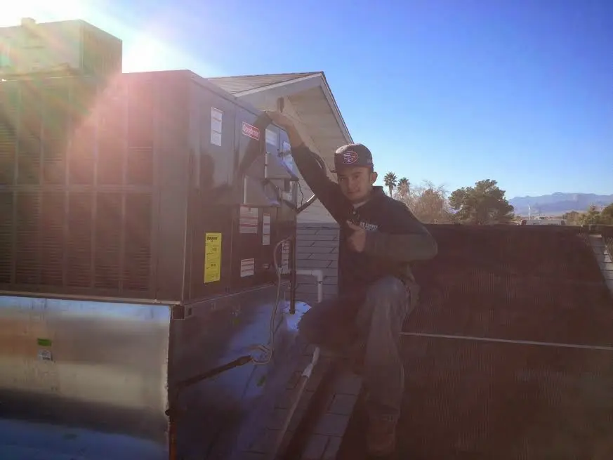 HVAC technician performing Boiler Repair on a rooftop unit in Upper Makefield